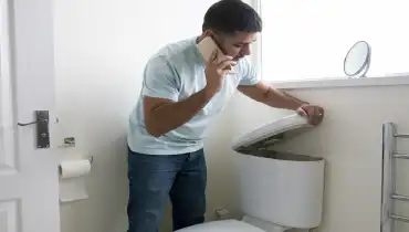 Man trying to fix a toilet | Mr. Rooter Plumbing of South Jersey