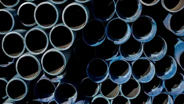 Stacked plastic piping material used for pipe lining in private plumbing systems.