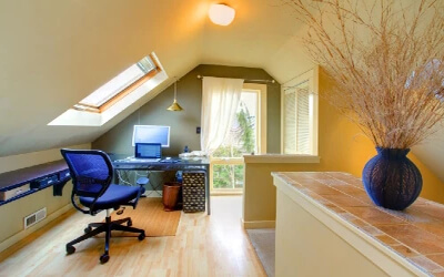 Home office with desk and large windows.