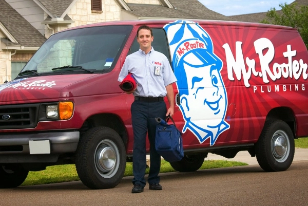 A plumber from Mr. Rooter Plumbing carrying tools used for tankless water heater installation in Waco, TX.