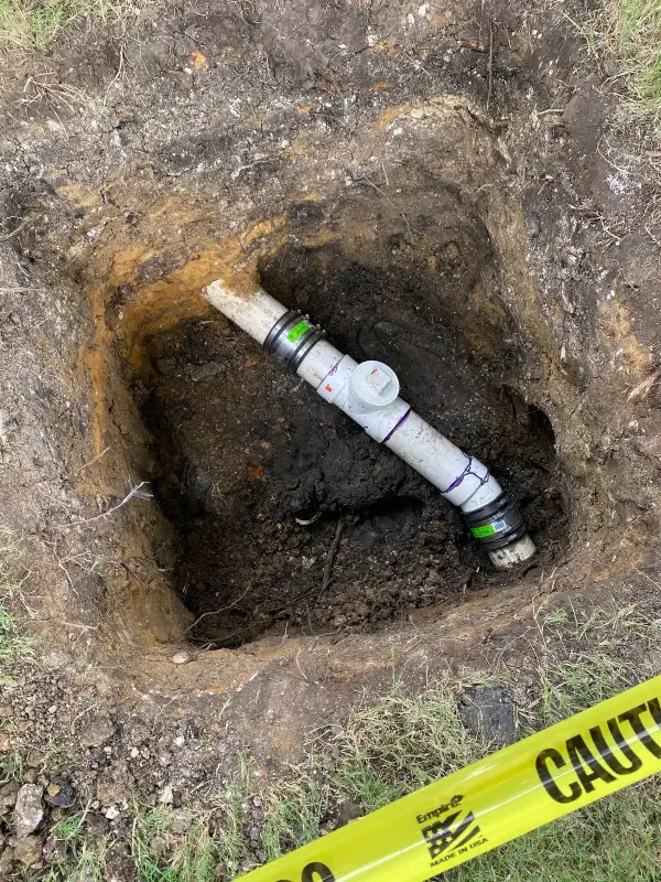 Exposed Dallas sewer line about to be repaired by Mr. Rooter Plumbing
