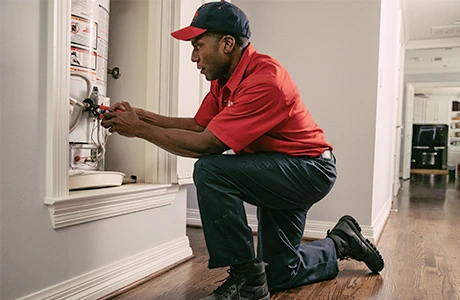 Mr. Rooter tech fixing water heater