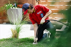 Mr. Rooter professional working outside of a home.