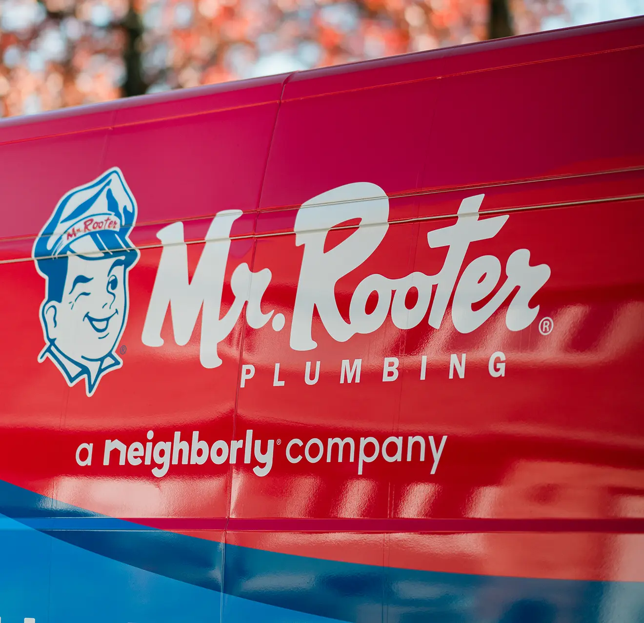 Mr. Rooter logo on the side of a branded work van.