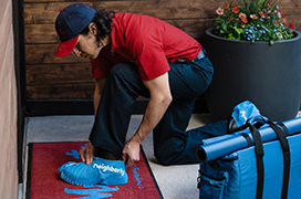 Mr. Rooter professional applying shoe covers before entering a home.