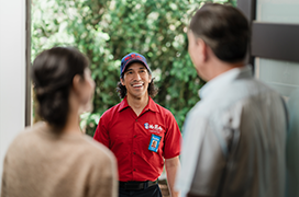 Mr. Rooter professional speaking with two customers.