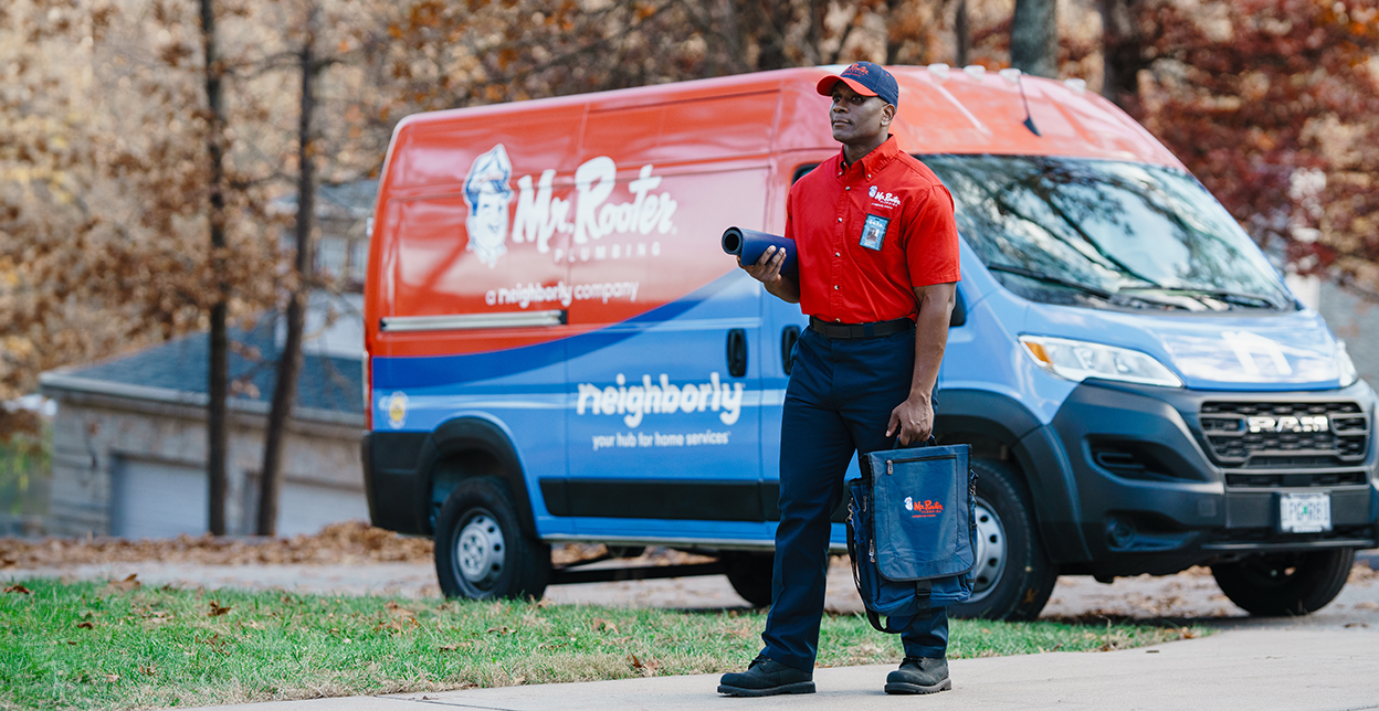 Mr. Rooter technician walking up to a customer's home.