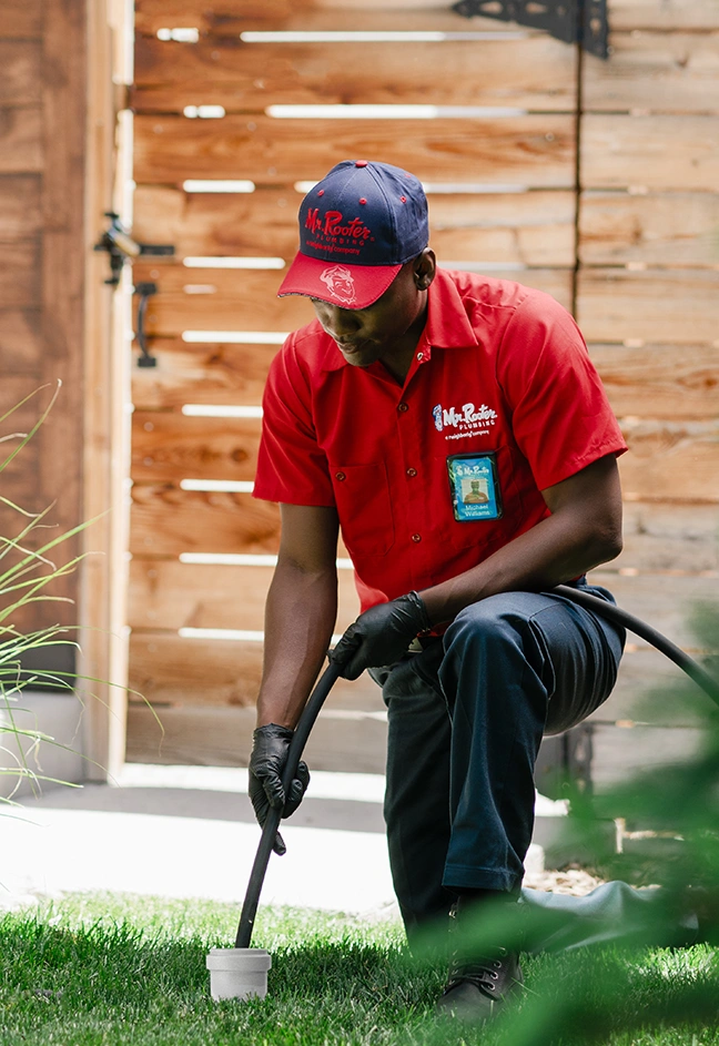 Mr. Rooter professional cleaning a sewer.