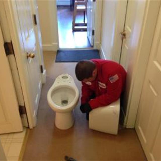 A Mr rooter technician Checking plumbing materials