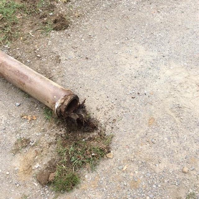 Close-up of old pipe clogged with dirt.