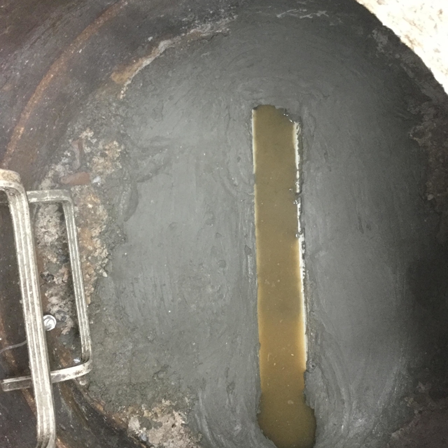 pipe with cement at bottom and ladder leading out