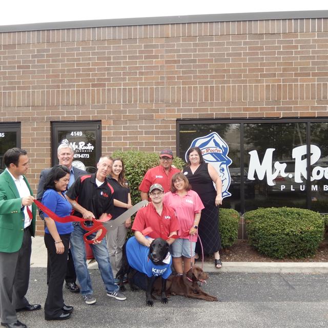 Mr Rooter employees cutting a ribbon