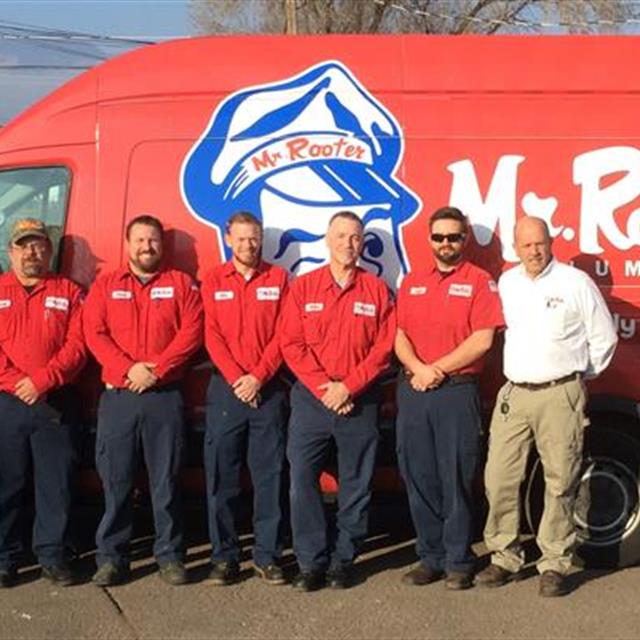 Mr Rooter employees standing by a van