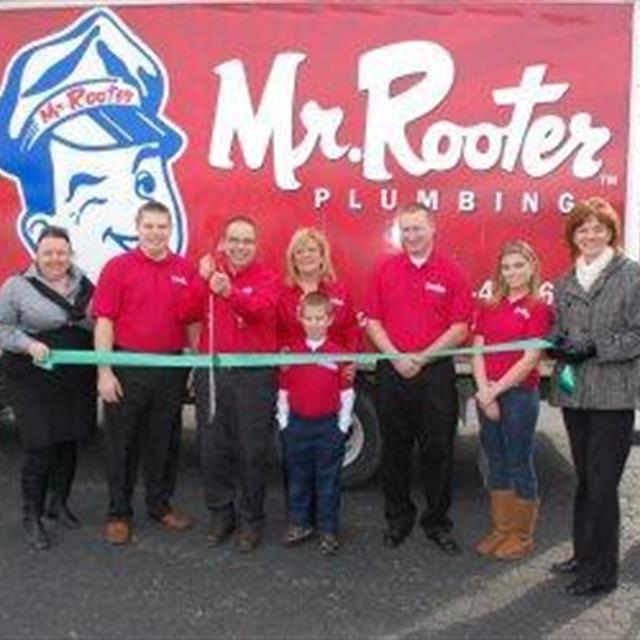 Mr Rooter technicians holding a ribbon