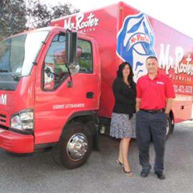 Mr. Rooter's staff in front of Mr. Rooter's van