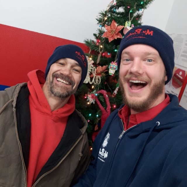 Mr. Rooter Employees by a Christmas Tree