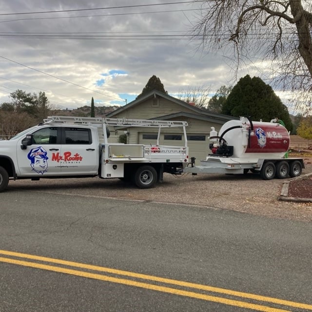 Mr. Rooter truck pulling a tank trailer.