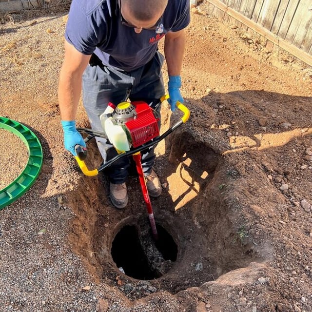 Mr.Rooter Employee with a tool that goes into a hole