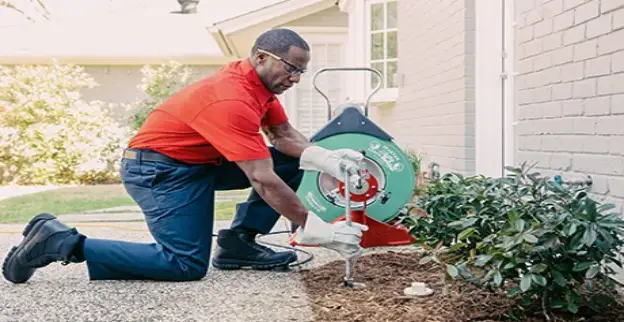 Mr. Rooter plumber arriving to assist a customer.