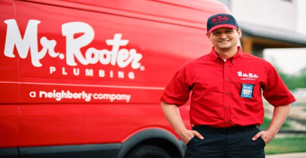 Mr. Rooter plumber standing beside his van in Bridge City, TX.