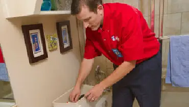 Mr. Rooter of Charlotte repairing toilet.