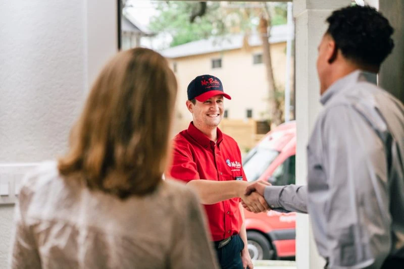 A Mr. Rooter plumber arriving to assist with plumbing repairs in Hudson, NH.