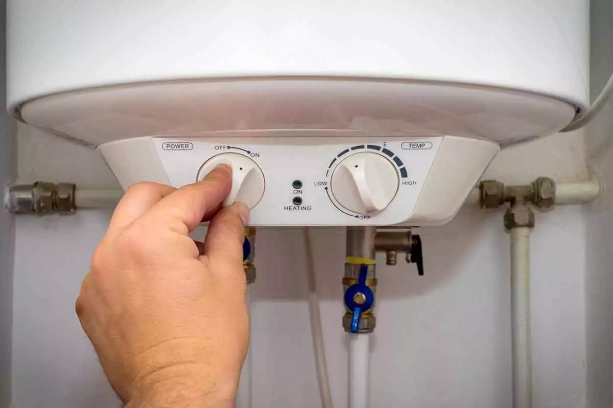 Person turning off a water heater