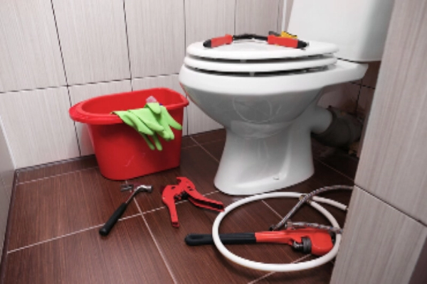 Plumber's tools on toilet at home