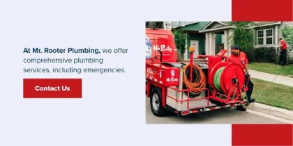 Mr. Rooter plumbers near a truck with plumbing equipments.