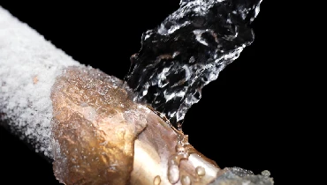 Frozen pipe being thawed out by warm water.