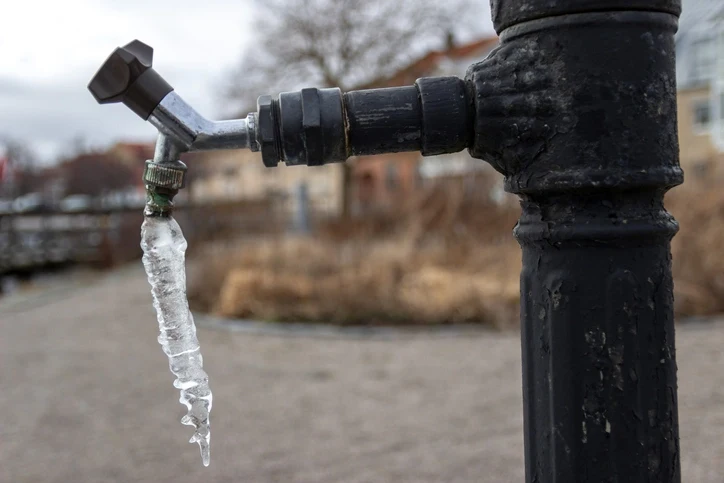 Icicle hanging from tap in early spring.