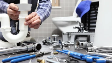 plumber at work in a bathroom, plumbing repair service, assemble and install concept.