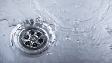 Bubbles coming from a flowing drain that needs to be cleaned.