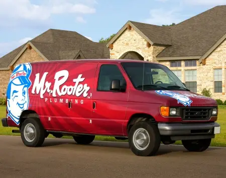 Mr. Rooter Van in front of a house