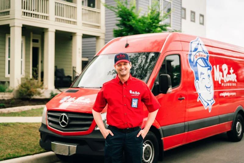 Mr. Rooter plumber standing in front of a work van before conducting a gas line replacement.