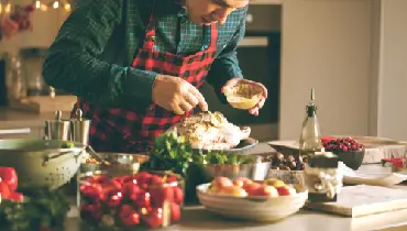 Stuffing a turkey.